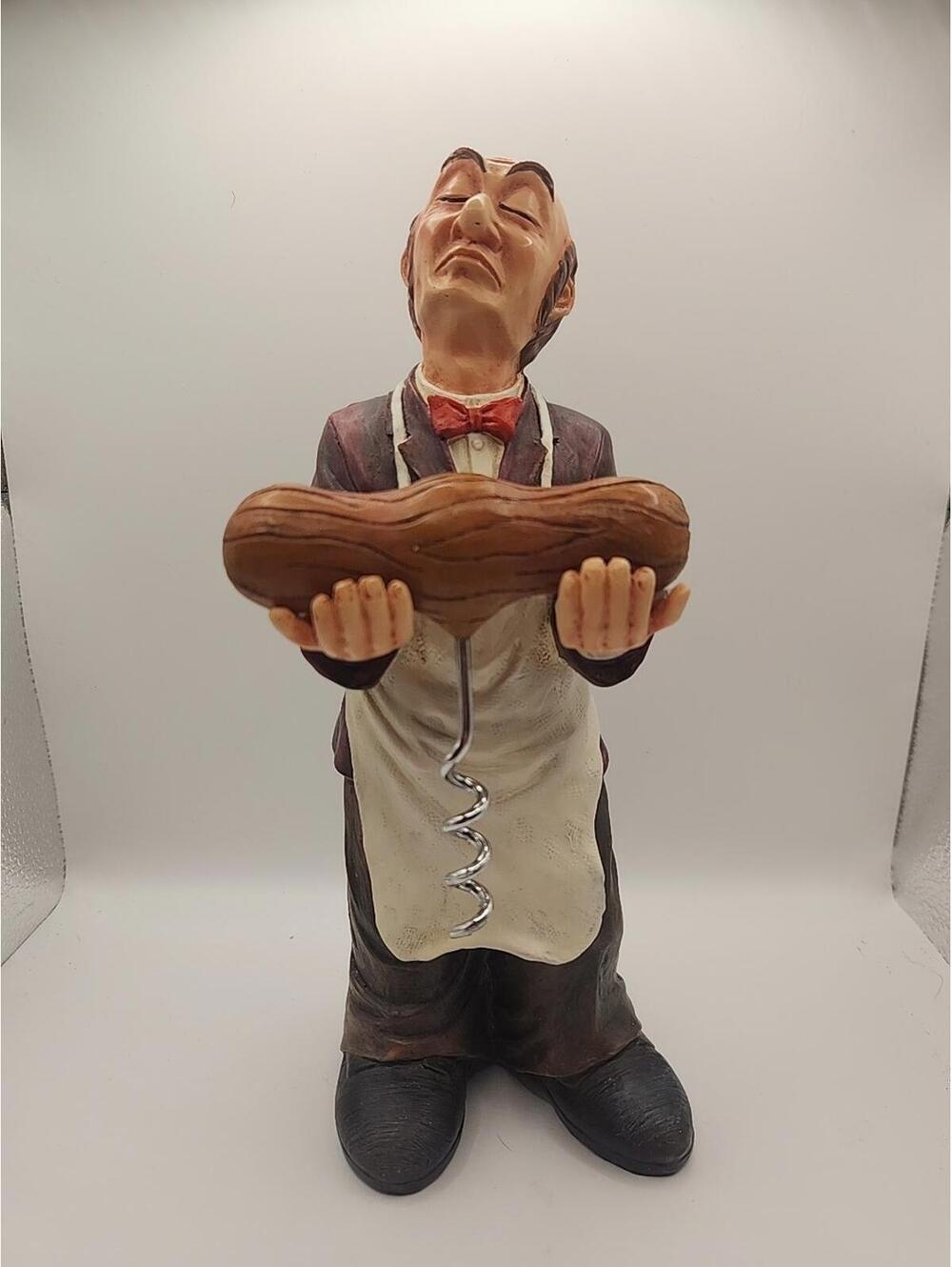 Old wine Butler holding a wine opener